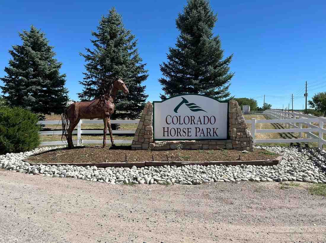Colorado Horse Park sign with a horse statue in front of trees